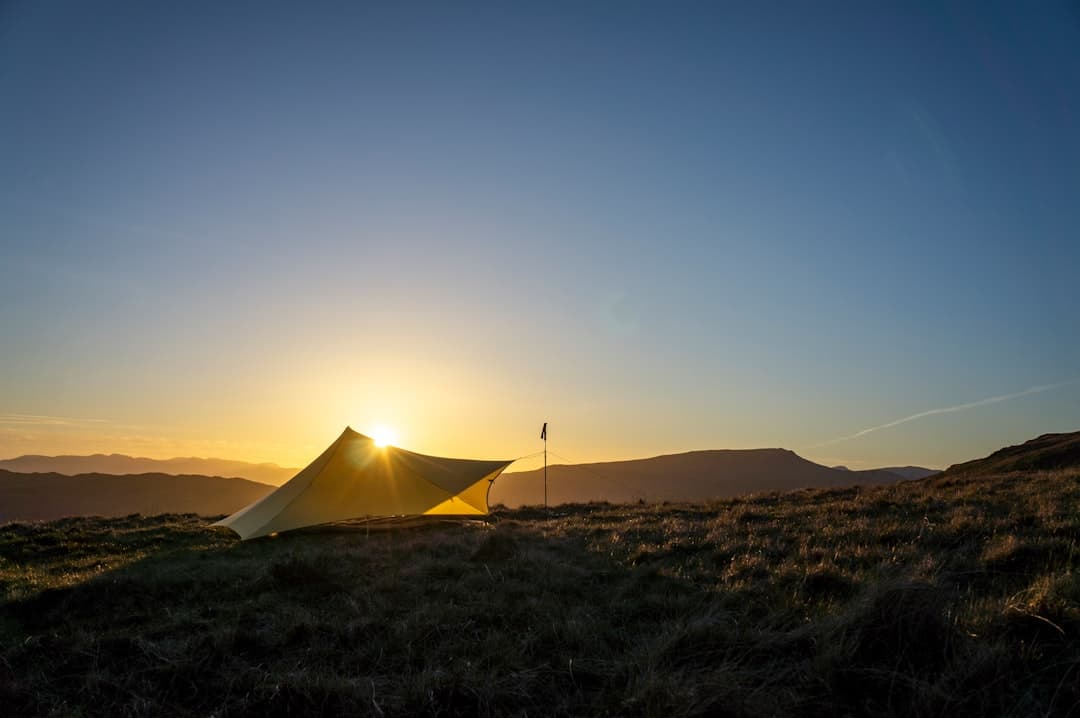 Wild camping tent by mountain lake